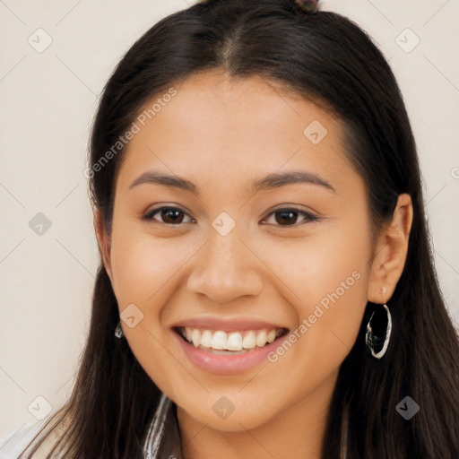 Joyful latino young-adult female with long  brown hair and brown eyes