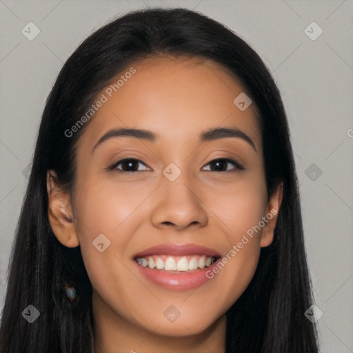 Joyful latino young-adult female with long  black hair and brown eyes