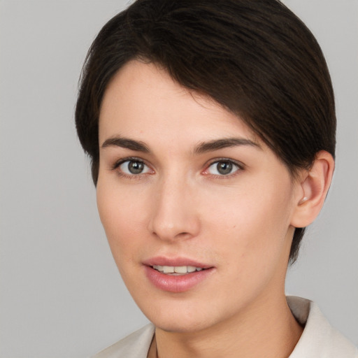 Joyful white young-adult female with short  brown hair and brown eyes