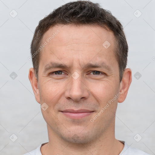 Joyful white adult male with short  brown hair and brown eyes