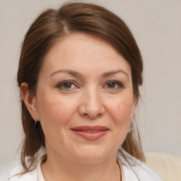 Joyful white adult female with medium  brown hair and brown eyes