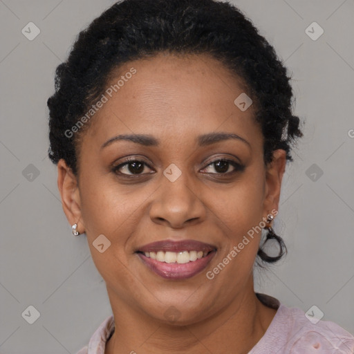 Joyful black adult female with short  brown hair and brown eyes