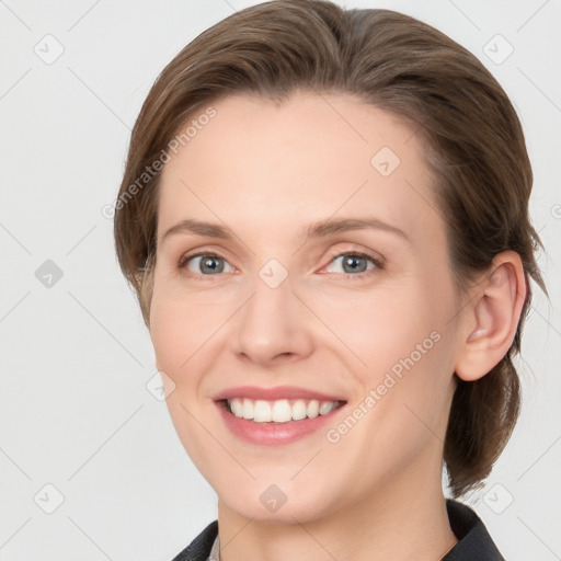 Joyful white young-adult female with medium  brown hair and grey eyes