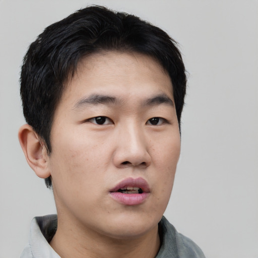 Neutral asian young-adult male with short  black hair and brown eyes
