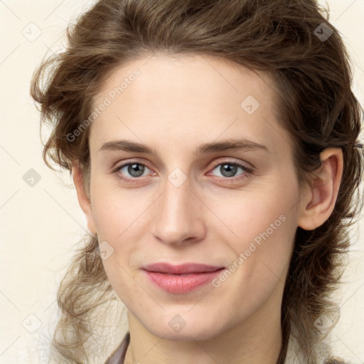 Joyful white young-adult female with medium  brown hair and green eyes