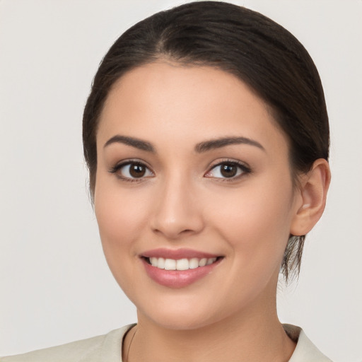 Joyful white young-adult female with medium  brown hair and brown eyes