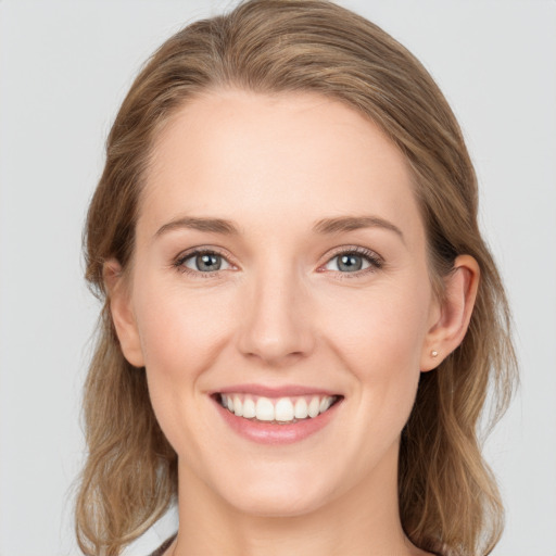 Joyful white young-adult female with medium  brown hair and blue eyes