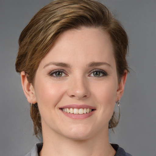 Joyful white young-adult female with medium  brown hair and grey eyes