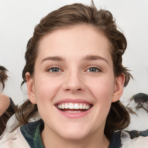 Joyful white young-adult female with medium  brown hair and green eyes