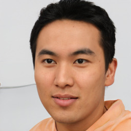 Joyful asian young-adult male with short  black hair and brown eyes