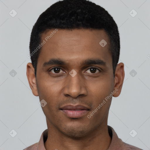 Joyful black young-adult male with short  black hair and brown eyes