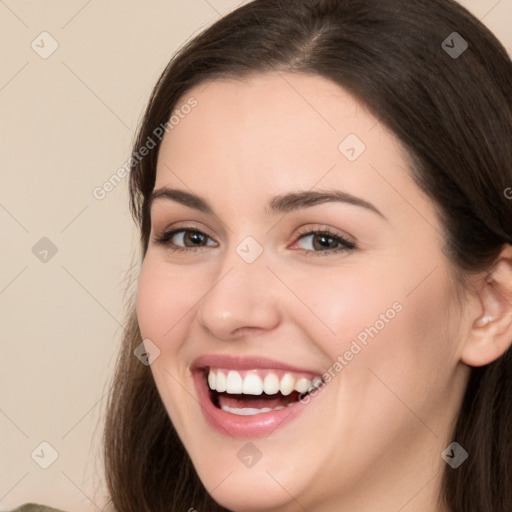 Joyful white young-adult female with long  brown hair and brown eyes