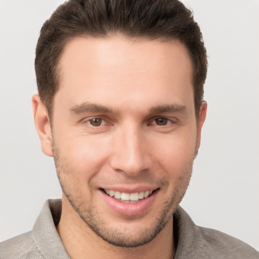 Joyful white young-adult male with short  brown hair and brown eyes