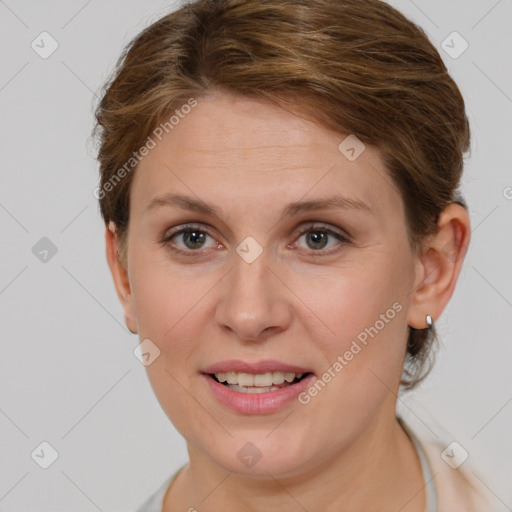 Joyful white young-adult female with short  brown hair and grey eyes