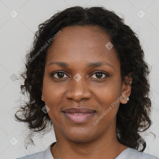 Joyful black young-adult female with long  brown hair and brown eyes