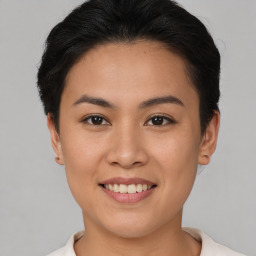 Joyful asian young-adult female with short  brown hair and brown eyes