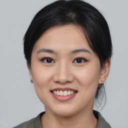 Joyful asian young-adult female with medium  black hair and brown eyes