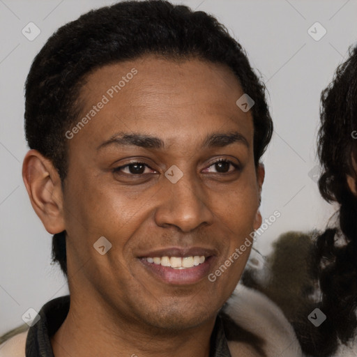 Joyful black adult male with short  brown hair and brown eyes