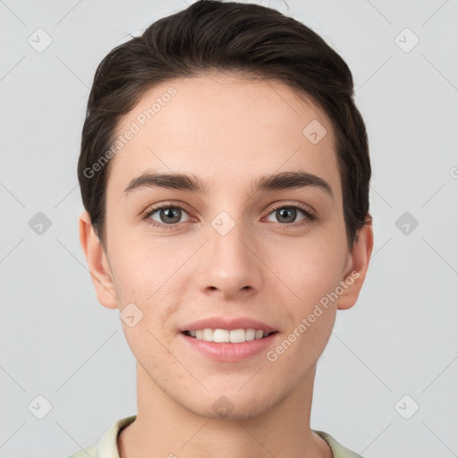 Joyful white young-adult male with short  brown hair and grey eyes