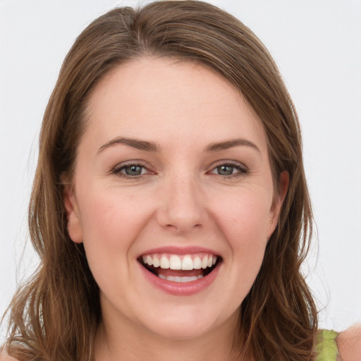 Joyful white young-adult female with long  brown hair and green eyes