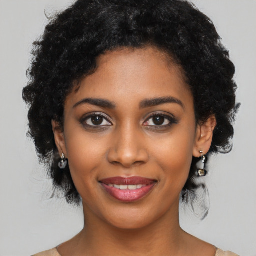 Joyful black young-adult female with medium  black hair and brown eyes