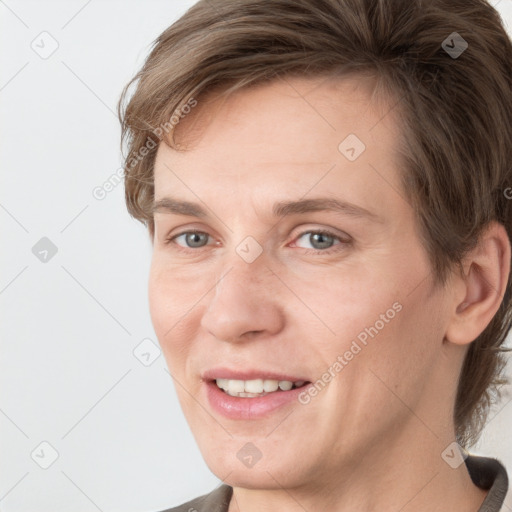 Joyful white adult female with medium  brown hair and grey eyes