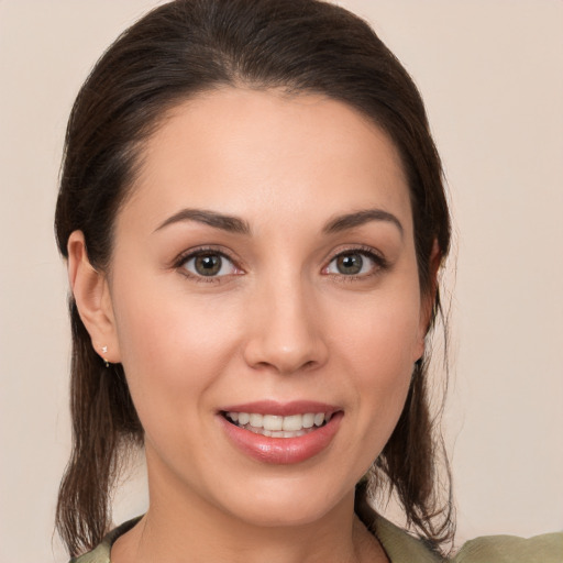 Joyful white young-adult female with medium  brown hair and brown eyes