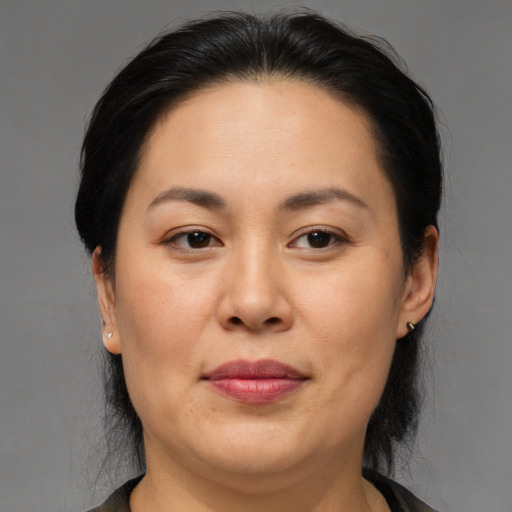 Joyful asian adult female with medium  brown hair and brown eyes