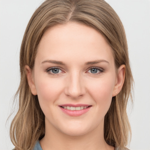 Joyful white young-adult female with long  brown hair and grey eyes