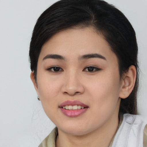Joyful asian young-adult female with medium  brown hair and brown eyes