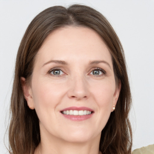 Joyful white young-adult female with long  brown hair and grey eyes