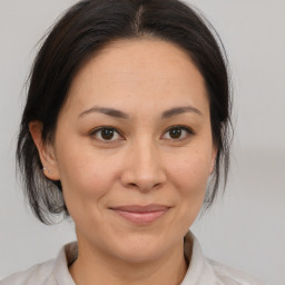 Joyful white adult female with medium  brown hair and brown eyes