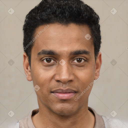 Joyful black young-adult male with short  black hair and brown eyes