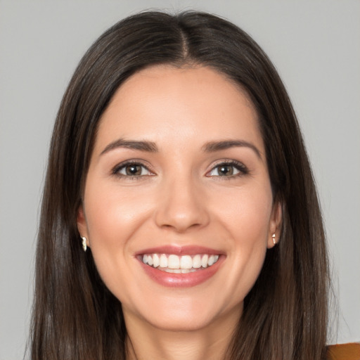 Joyful white young-adult female with long  brown hair and brown eyes