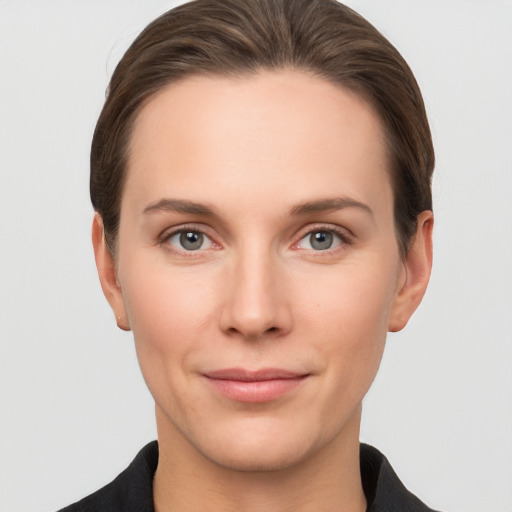 Joyful white young-adult female with short  brown hair and grey eyes