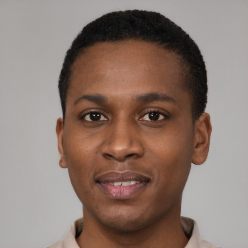 Joyful black young-adult male with short  black hair and brown eyes