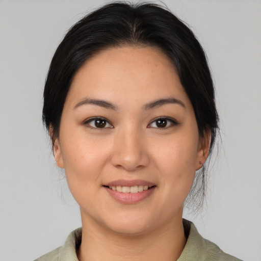 Joyful asian young-adult female with medium  brown hair and brown eyes