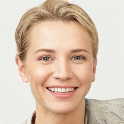 Joyful white young-adult female with short  brown hair and blue eyes