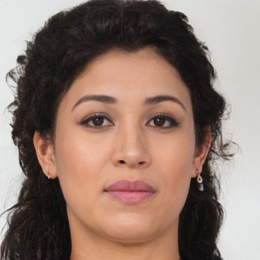 Joyful latino young-adult female with long  brown hair and brown eyes