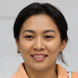 Joyful asian young-adult female with medium  brown hair and brown eyes