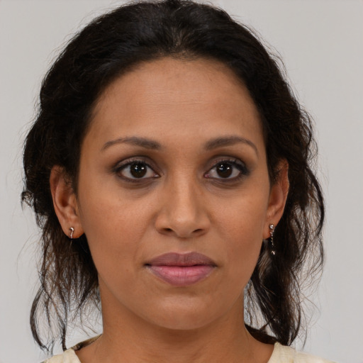 Joyful black adult female with medium  brown hair and brown eyes