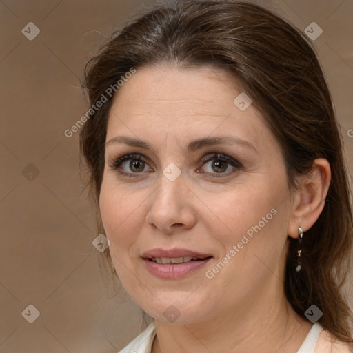 Joyful white adult female with medium  brown hair and brown eyes