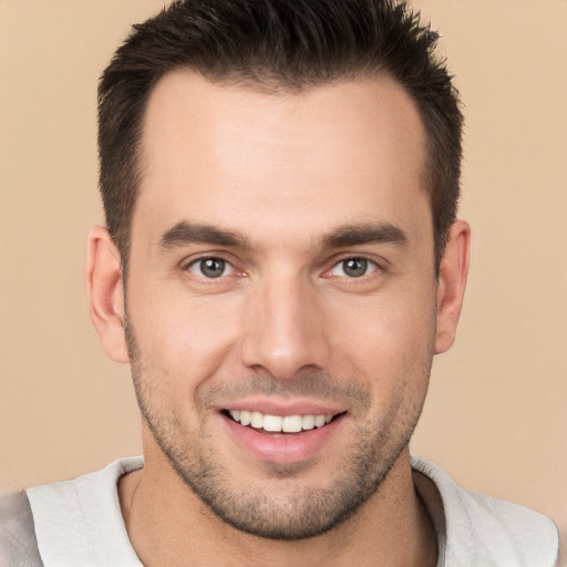 Joyful white young-adult male with short  brown hair and brown eyes