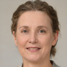 Joyful white adult female with medium  brown hair and grey eyes