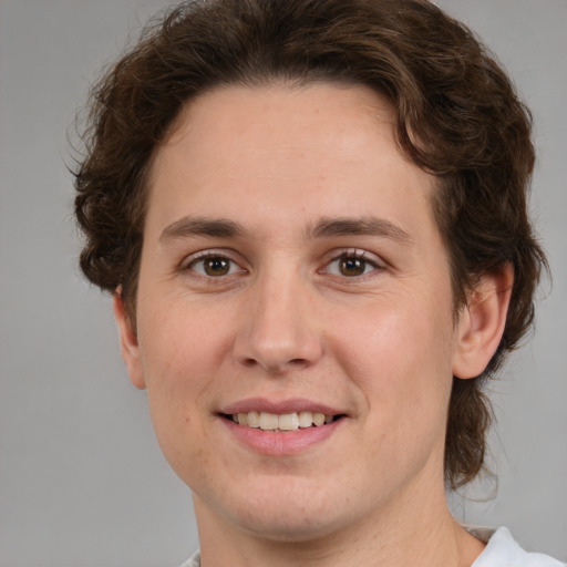 Joyful white young-adult male with medium  brown hair and brown eyes