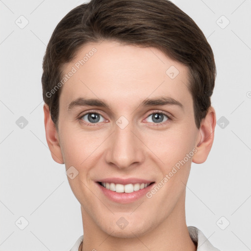 Joyful white young-adult male with short  brown hair and grey eyes