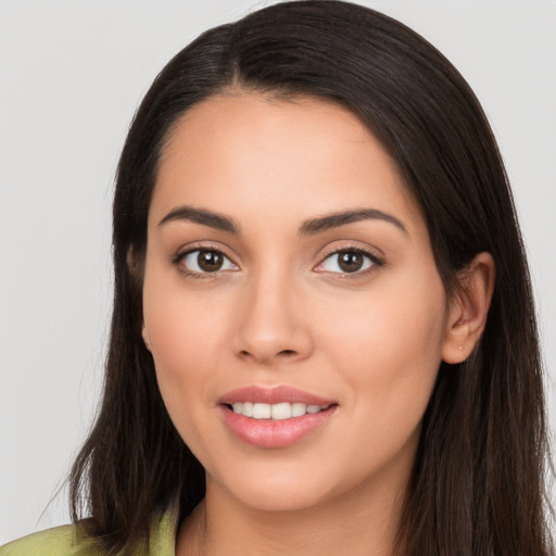 Joyful white young-adult female with long  brown hair and brown eyes