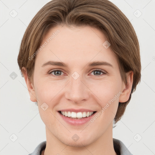 Joyful white young-adult female with short  brown hair and grey eyes