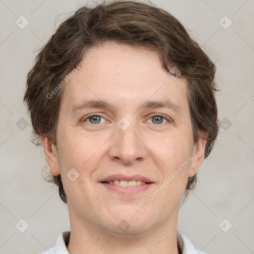 Joyful white adult male with short  brown hair and grey eyes