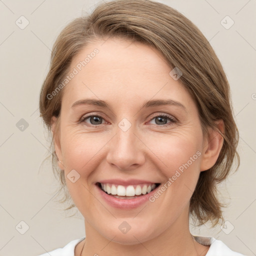 Joyful white young-adult female with medium  brown hair and green eyes